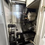Technical Buyer’s Handbook: Assessing Pre-Owned , Used , Secondhand, Surplus CNC Machines Before Purchase Okuma GENOS L300-M-e CNC Turning Center with Edge Technologies Rebel V-80 Bar Feeder made in Japan