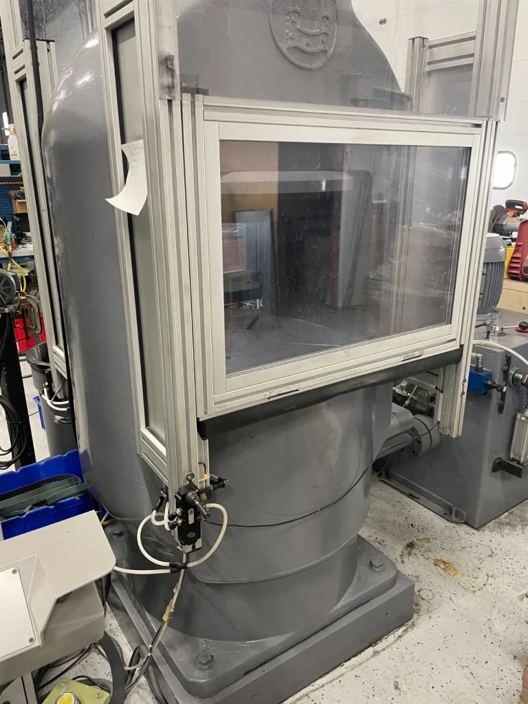 What is a hydraulic coining and medal press used for in producing high-quality coins, medals, bars, and industrial pressed parts?